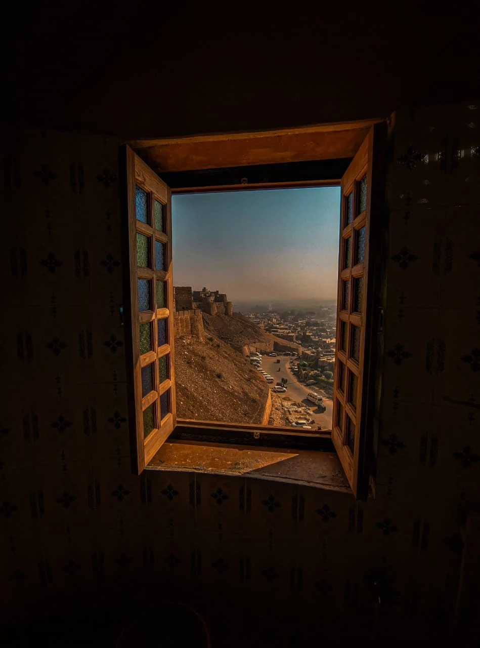 The city framed through an open window