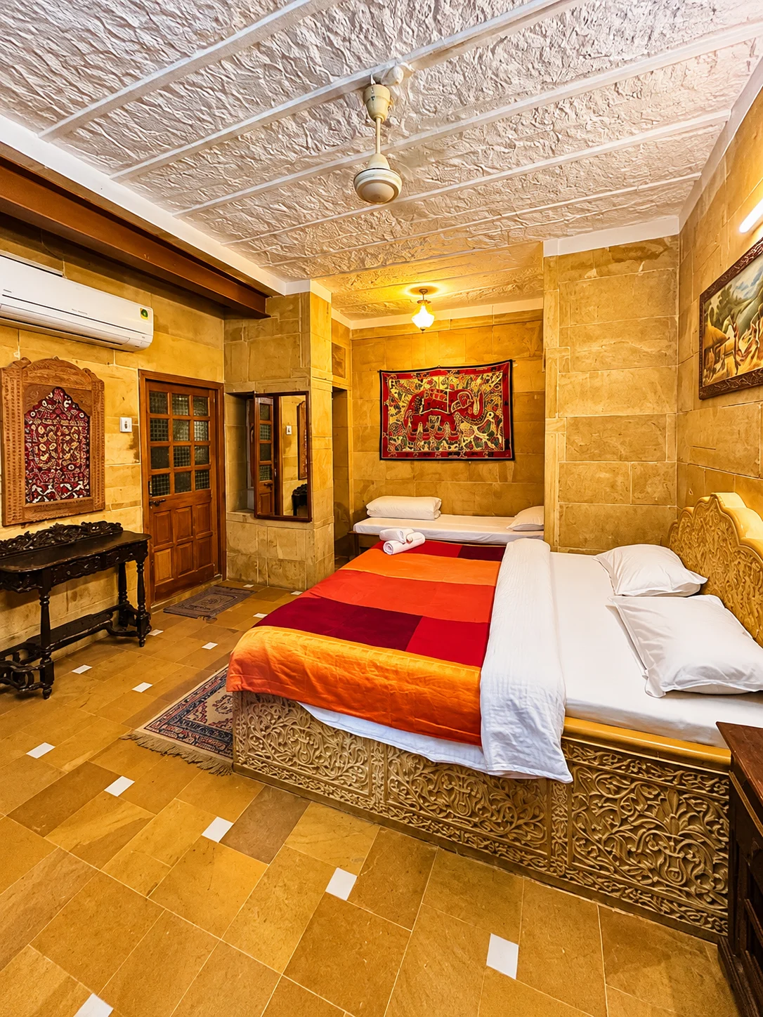 3-Star Hotel — Warm sandstone interiors with carved ceilings and colourful textiles.